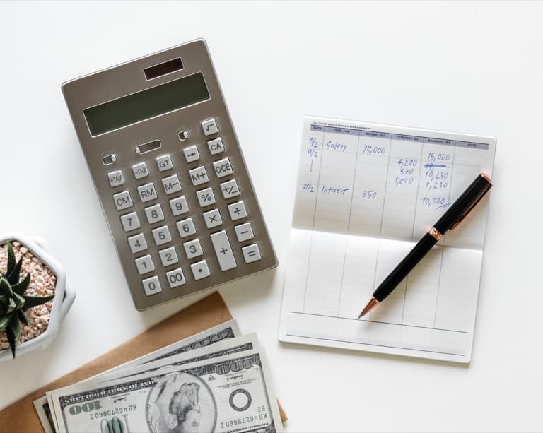 Balancing check book with money laid out