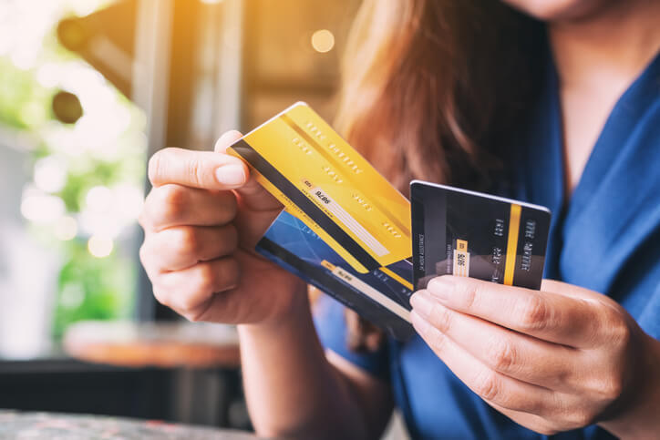 woman holding multiple credit cards in her hands
