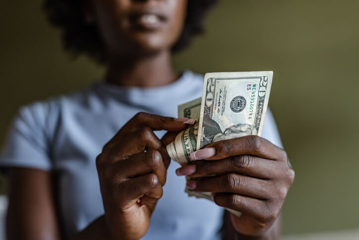 woman counting cash in her hands