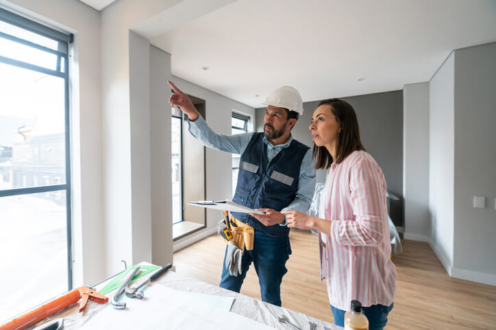 a contractor talking to a homeowner about renovations