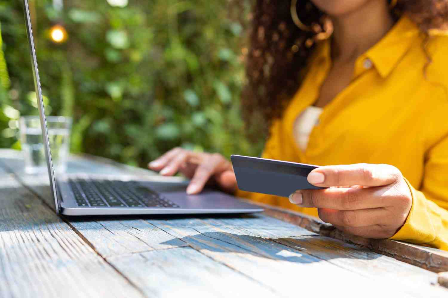 person on their laptop looking at their credit card